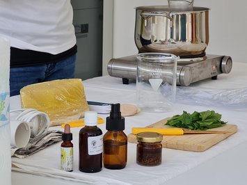 Seiser Alm Balance: active & healthy throughout spring Various bottles, herbs, and equipment on kitchen table for natural remedies