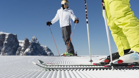 Immagini che emozionano: appartamenti Presulis a Fiè Sciatori su pista appena preparata con montagne sullo sfondo cielo sereno